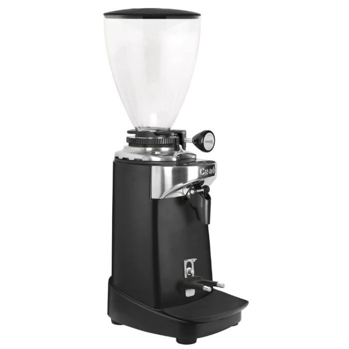 A black coffee grinder with a clear hopper, silver metal accents, and a black foot pedal, shown against a plain white background.