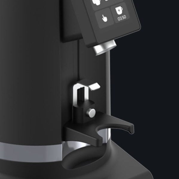 Close-up of a modern espresso machine with a matte black body, silver metallic accents, and a digital display screen showing time and temperature settings.