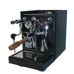 A professional espresso machine with a matte black metal body, polished chrome metal components, and dark wood handles, shown on a pure white background.